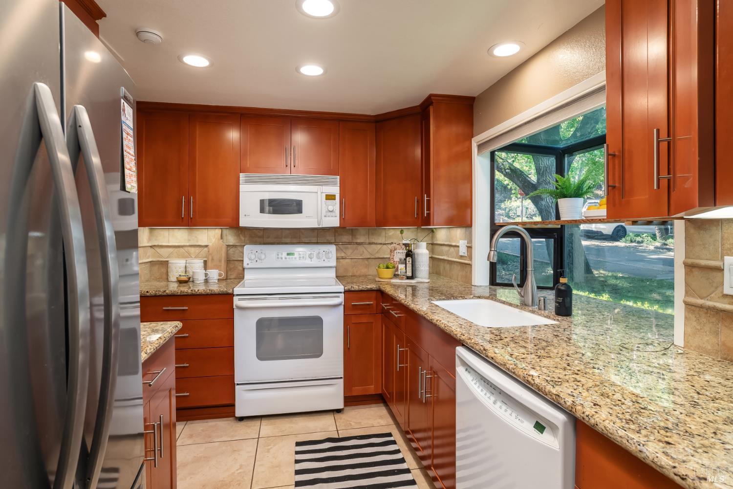 4 California Condor Way Novato, CA 94949 - Photo 10 of 20 a kitchen with stainless steel appliances granite countertop a sink stove and refrigerator