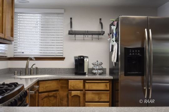 516 South Sorrel Street Ridgecrest, CA 93555 - Photo 4 of 32 a kitchen with stainless steel appliances granite countertop a refrigerator and a sink