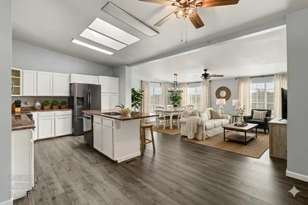 a open kitchen with white cabinets and stainless steel appliances