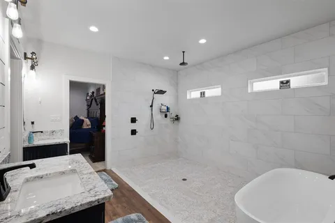 a large bathroom with a granite countertop sink and a mirror