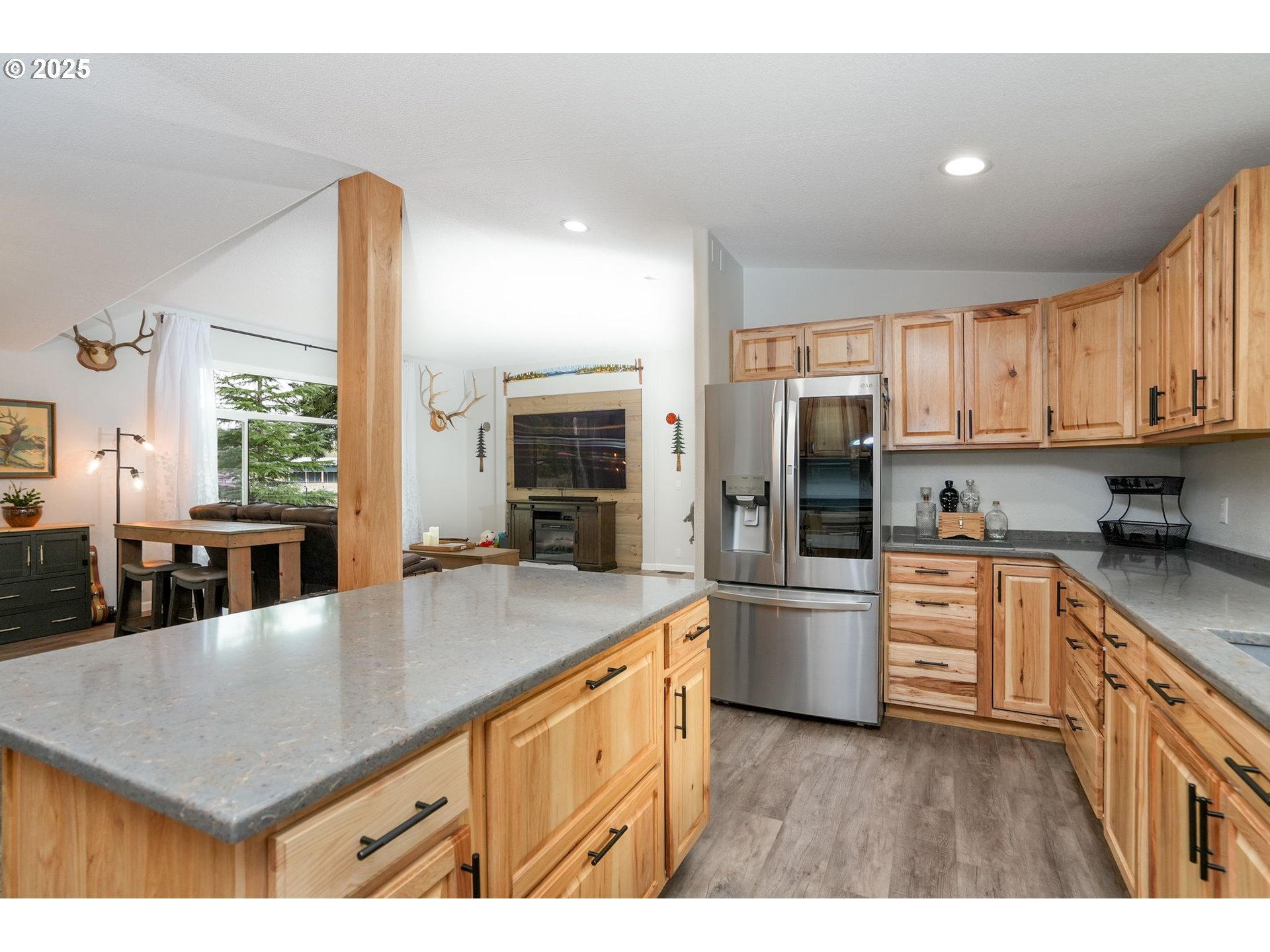 40219 North Dogwood Road Mill City, OR 97360 - Photo 13 of 47 a kitchen with stainless steel appliances granite countertop a refrigerator a stove and a sink with wooden floors