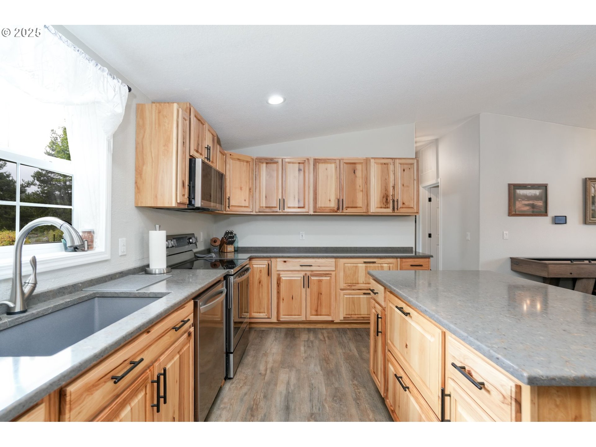 40219 North Dogwood Road Mill City, OR 97360 - Photo 15 of 47 a kitchen with stainless steel appliances granite countertop a sink stove and cabinets