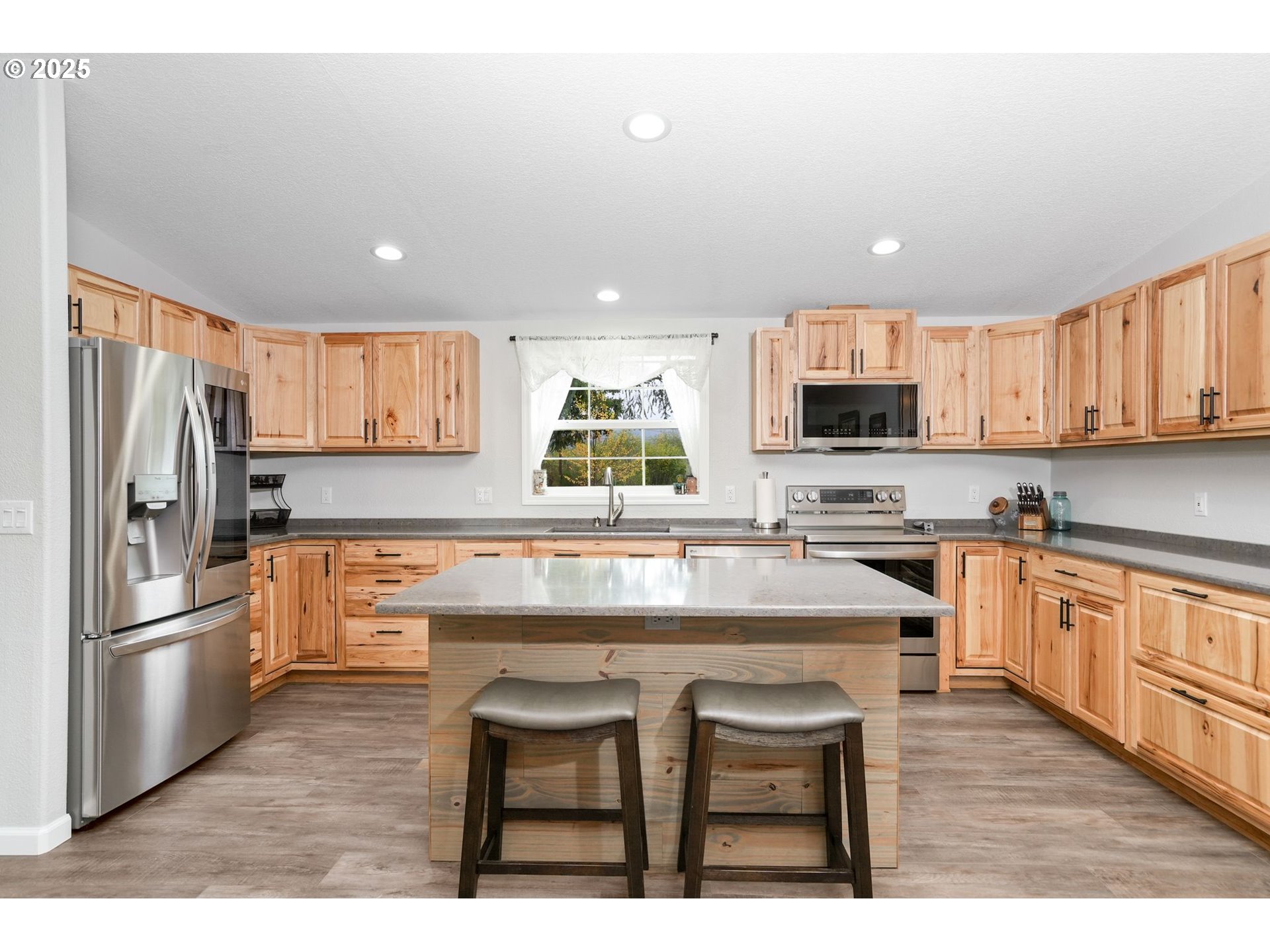 40219 North Dogwood Road Mill City, OR 97360 - Photo 16 of 47 a kitchen with stainless steel appliances granite countertop a stove refrigerator sink and microwave