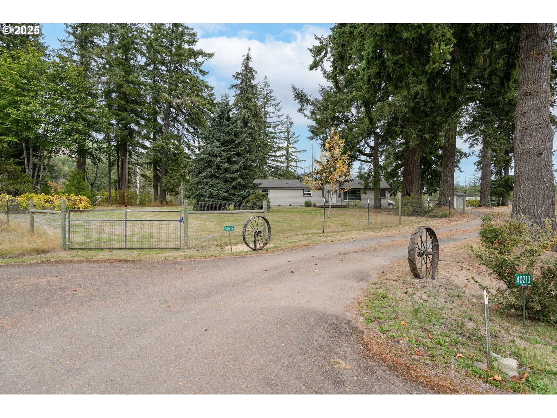 40219 North Dogwood Road Mill City, OR 97360 - Photo 3 of 47 a backyard of a house with barbeque oven and outdoor seating