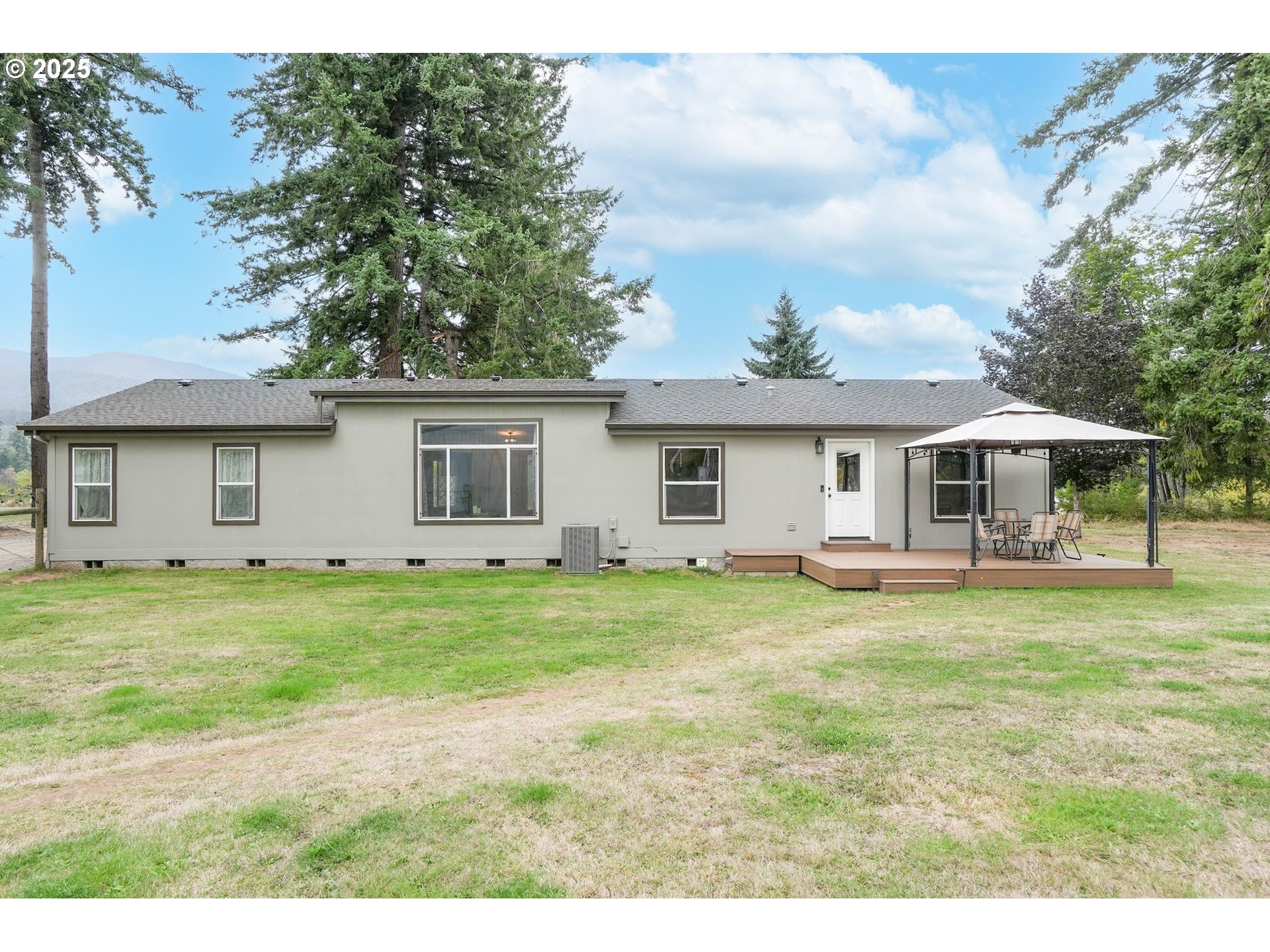 40219 North Dogwood Road Mill City, OR 97360 - Photo 32 of 47 a backyard of a house with table and chairs