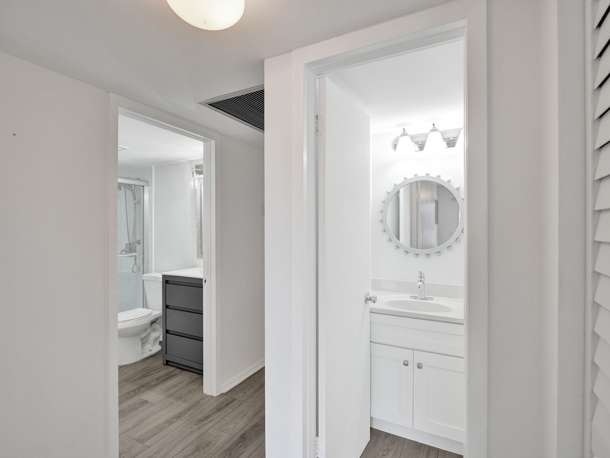 1031 Exeter, Unit 1031 Boca Raton, FL 33434 - Photo 15 of 24 a bathroom with a sink and a mirror