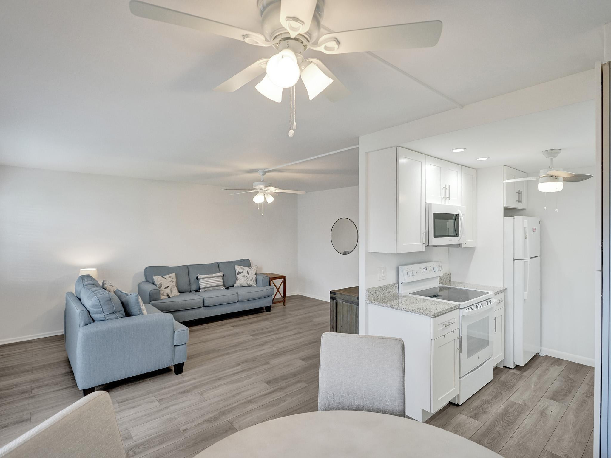 1031 Exeter, Unit 1031 Boca Raton, FL 33434 - Photo 8 of 24 a living room with furniture and a wooden floor