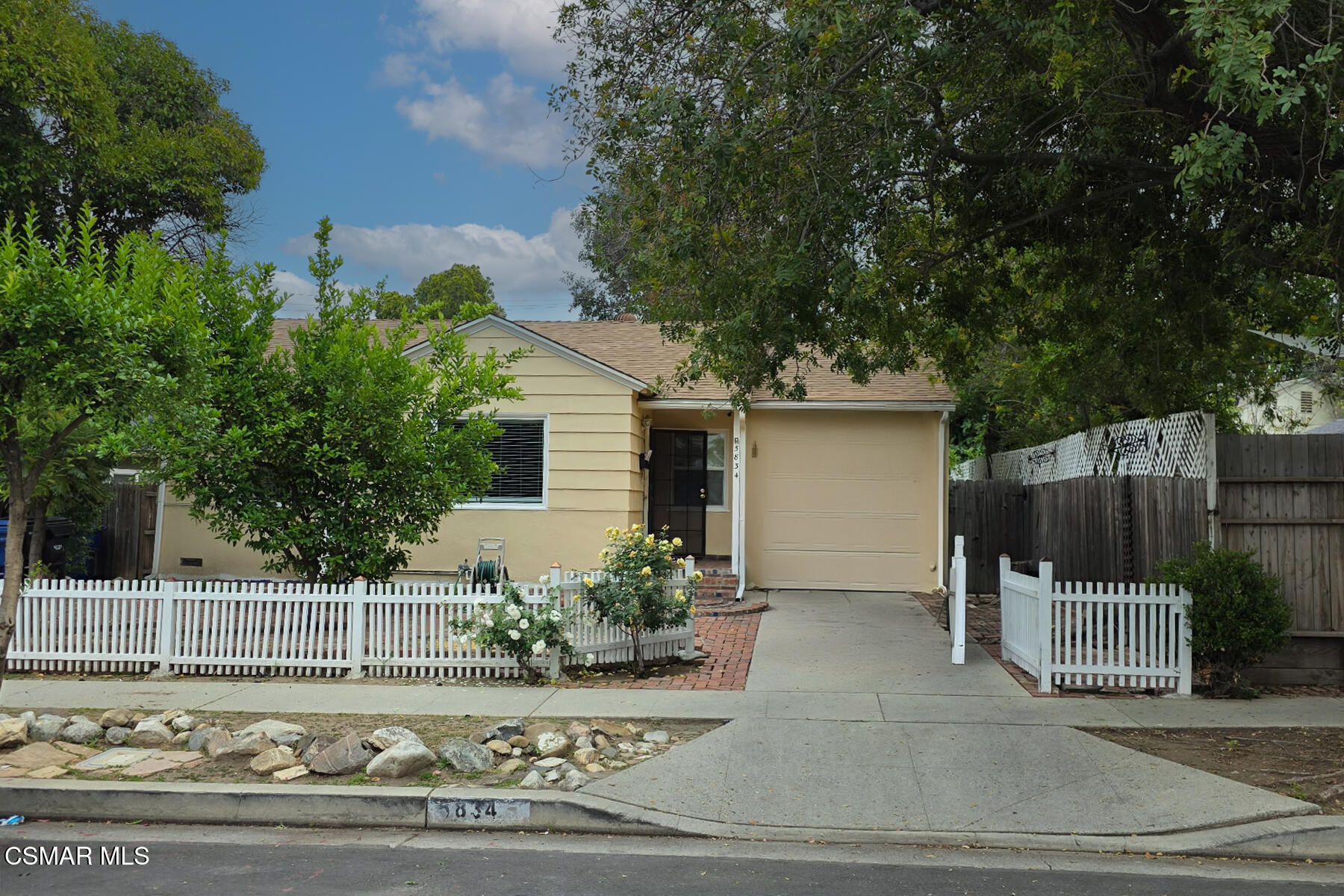 5834 Balcom Avenue Encino, CA 91316 - Photo 1 of 10 a view of a house with a yard and fence