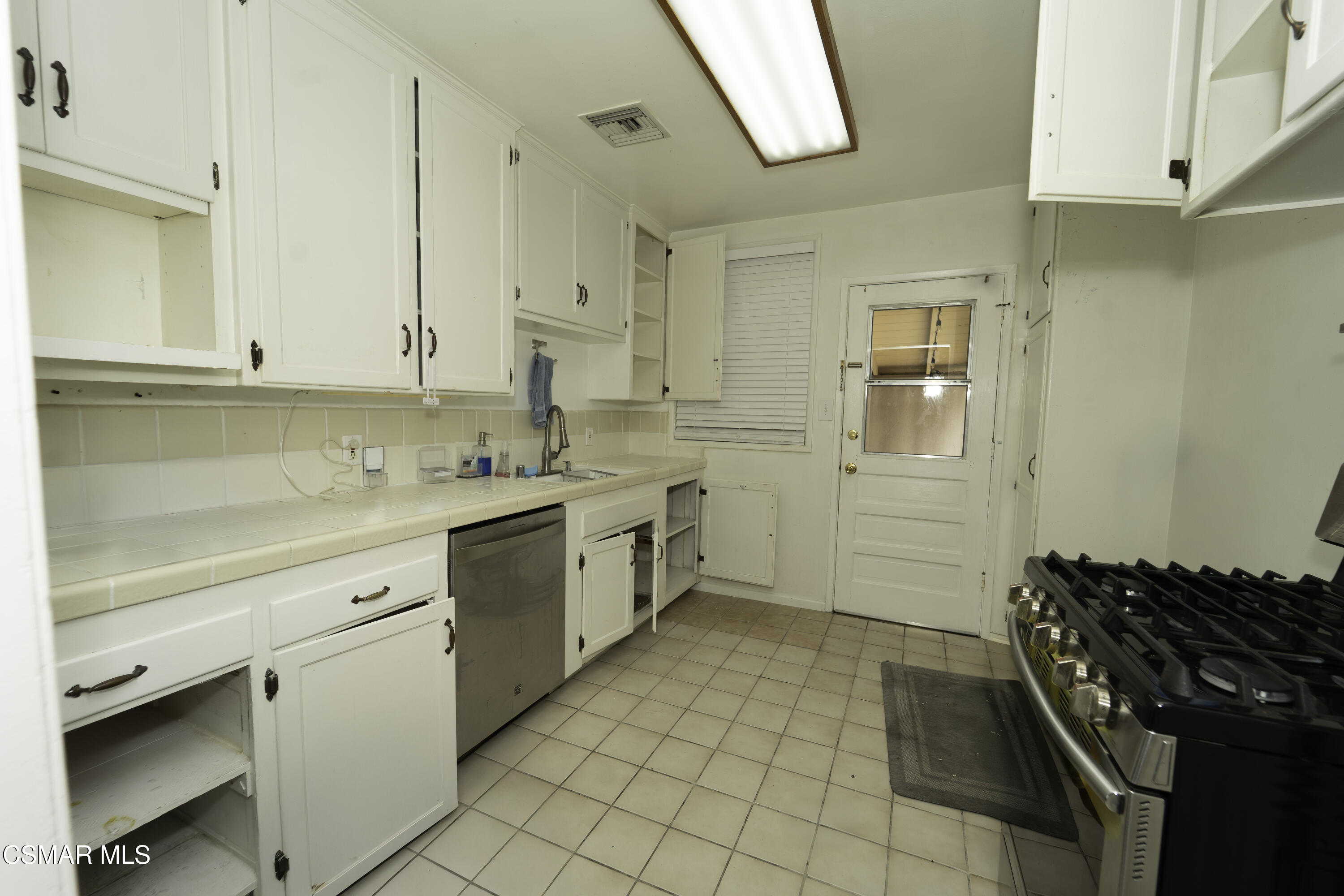 5834 Balcom Avenue Encino, CA 91316 - Photo 3 of 10 a kitchen with a stove cabinets and a sink