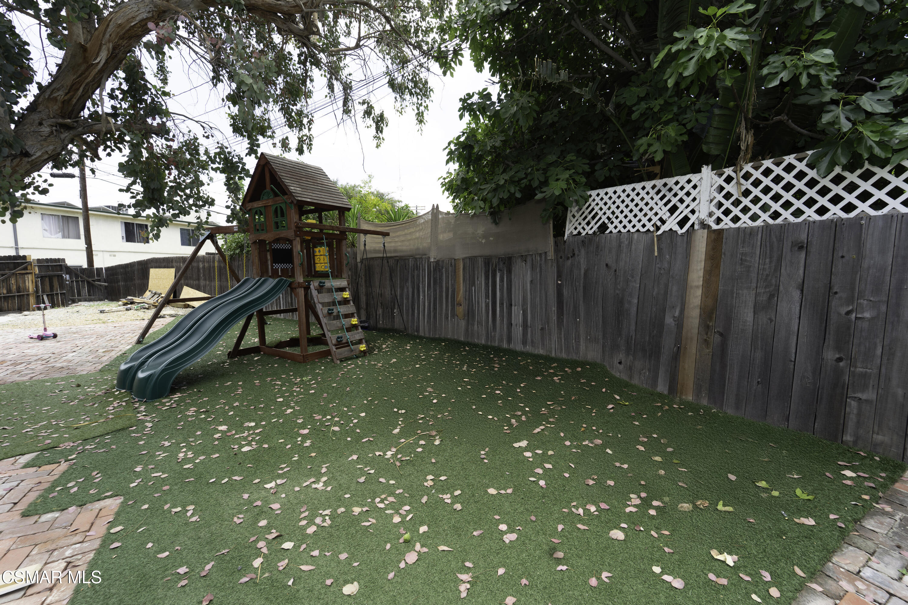 5834 Balcom Avenue Encino, CA 91316 - Photo 7 of 10 a view of a backyard with wooden fence and a bench