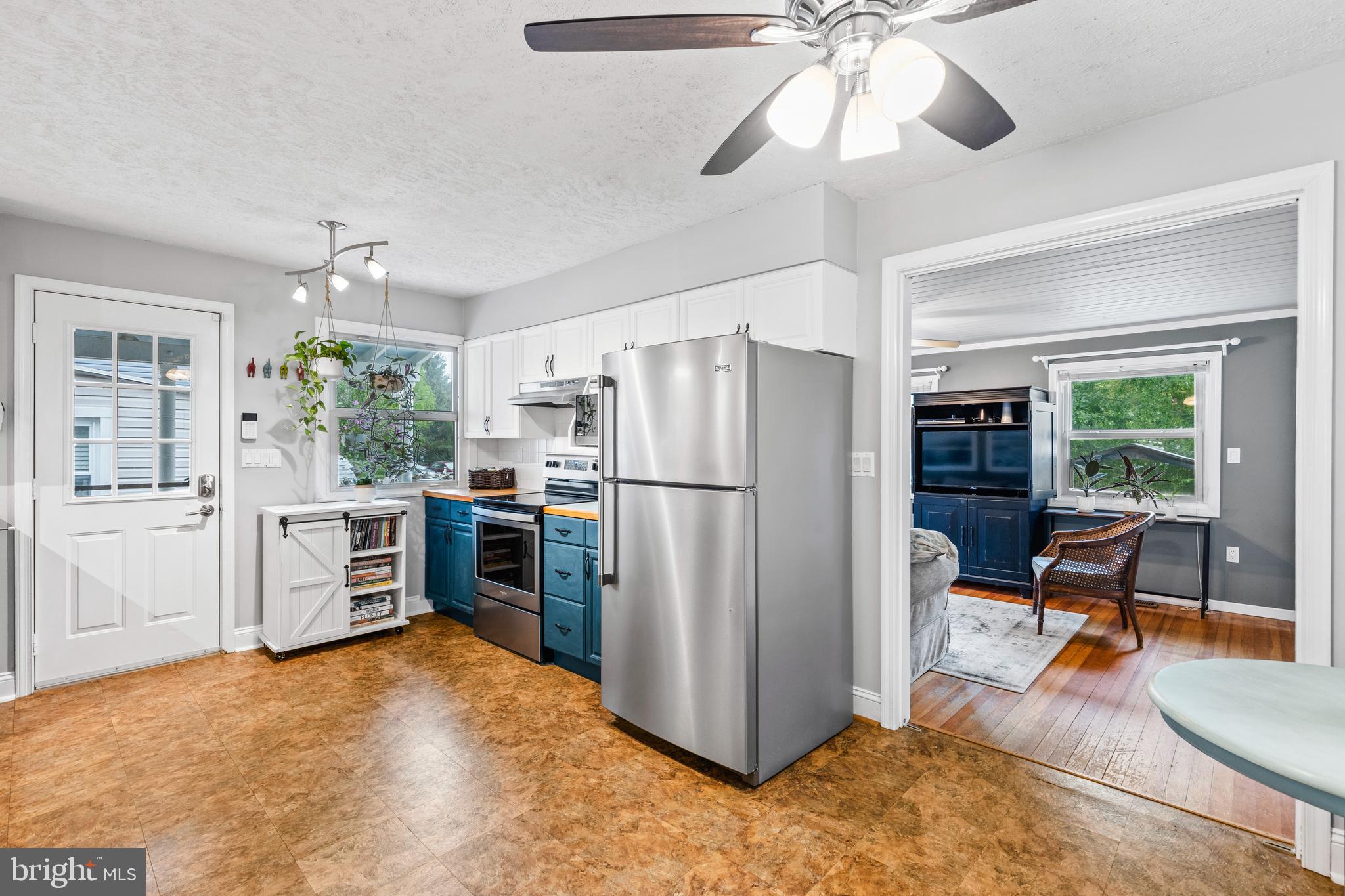106 Orchard Road Riva, MD 21140 - Photo 12 of 38 a kitchen with refrigerator a stove a dining table and chairs with wooden floor