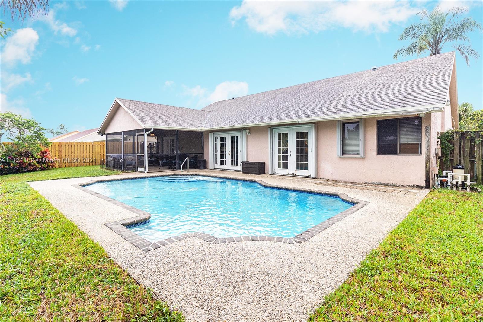 9248 Neptunes Basin Court Boca Raton, FL 33434 - Photo 2 of 34 a view of a house with swimming pool and a yard