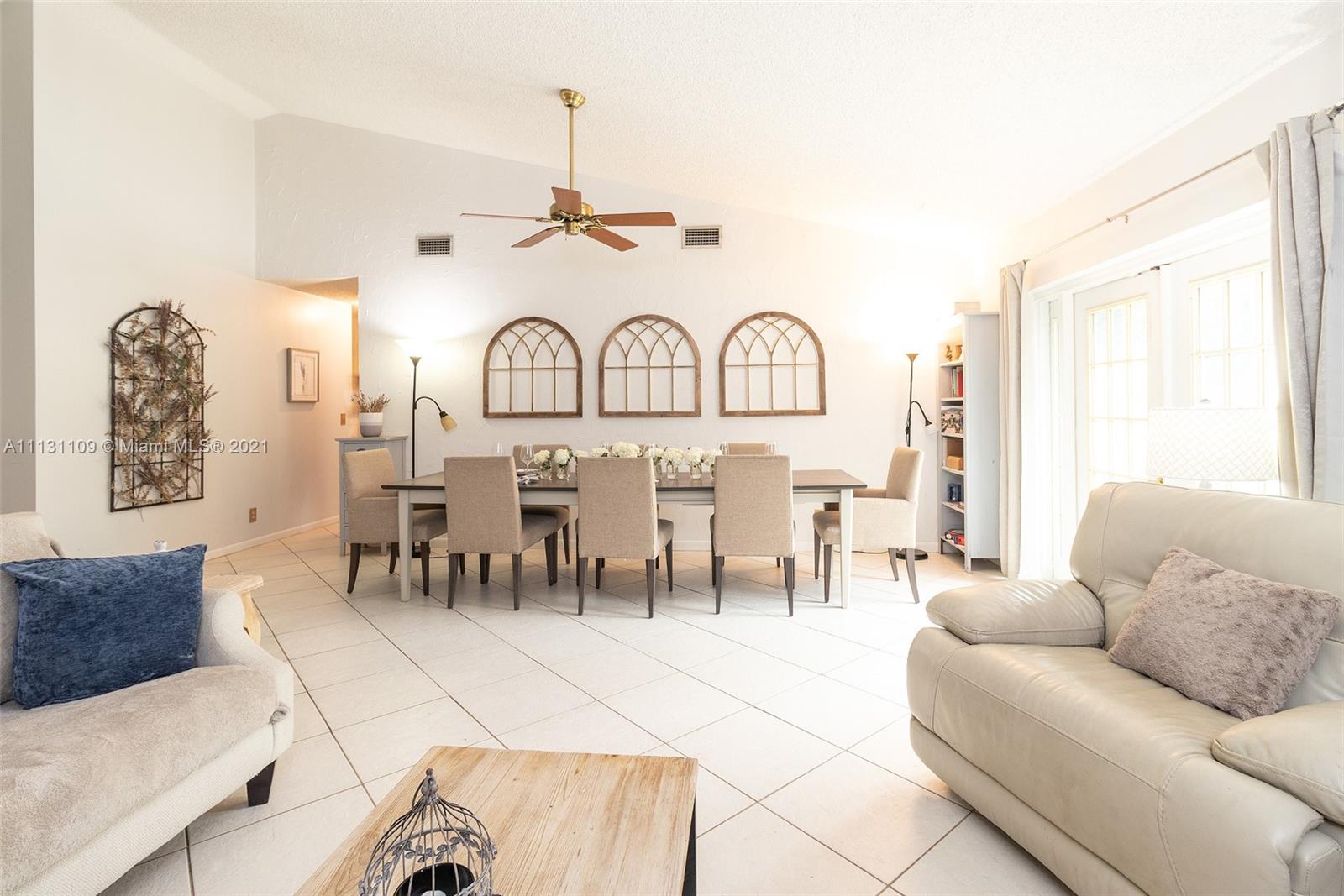9248 Neptunes Basin Court Boca Raton, FL 33434 - Photo 11 of 34 a living room with furniture a clock and a large window