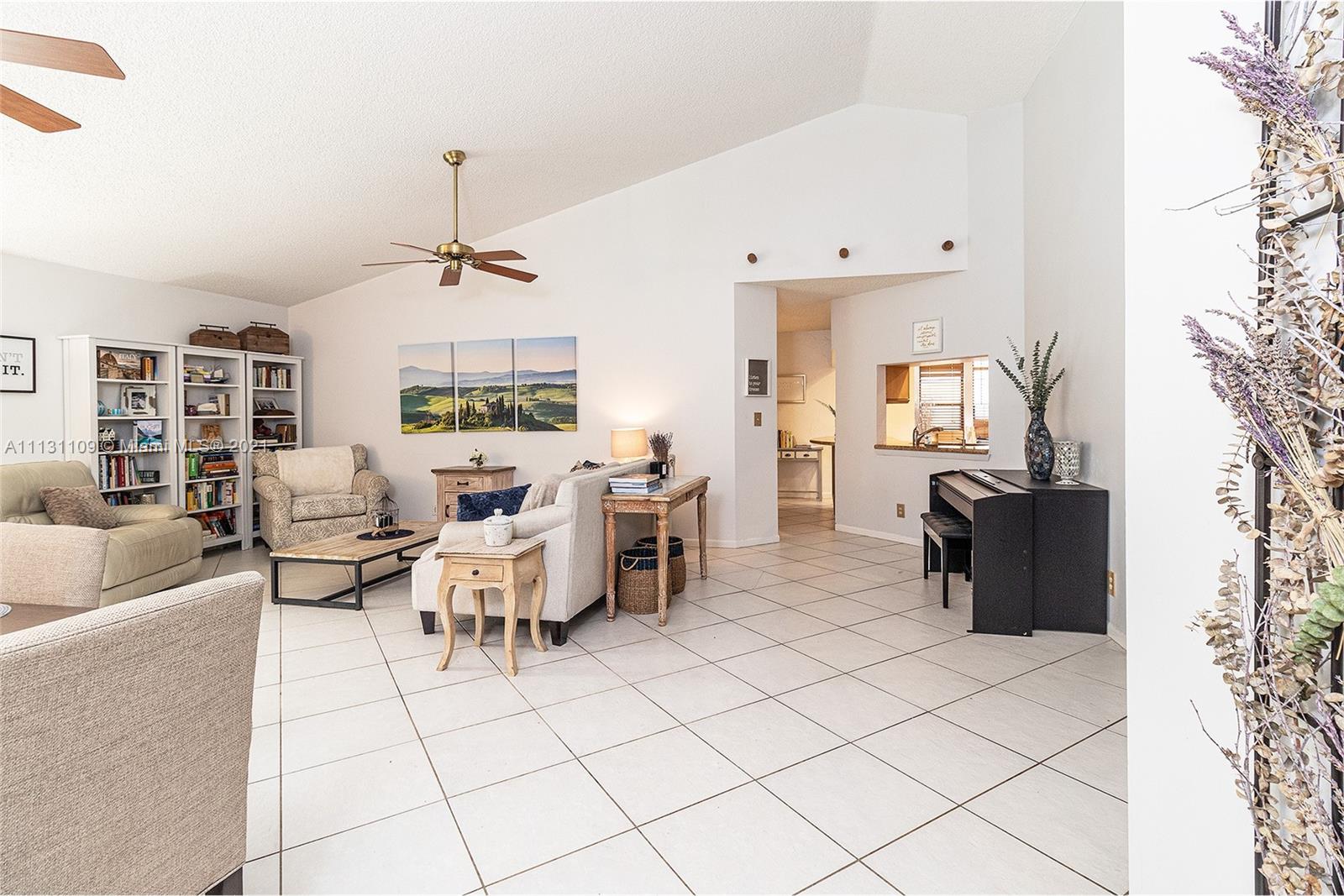 9248 Neptunes Basin Court Boca Raton, FL 33434 - Photo 12 of 34 a living room with furniture and a chandelier