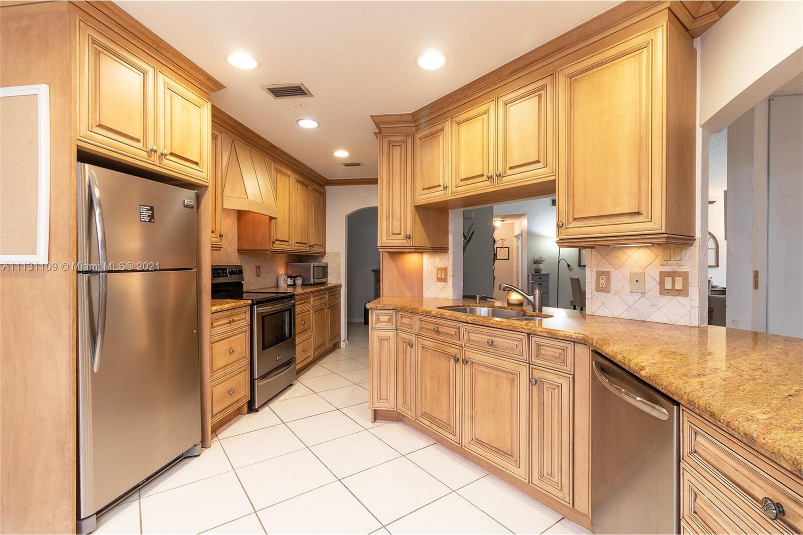 9248 Neptunes Basin Court Boca Raton, FL 33434 - Photo 14 of 34 a kitchen with stainless steel appliances granite countertop a refrigerator a stove and a sink