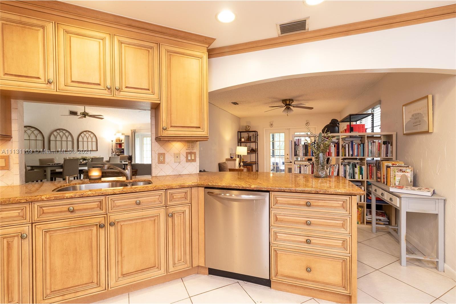 9248 Neptunes Basin Court Boca Raton, FL 33434 - Photo 15 of 34 a kitchen with cabinets and chairs