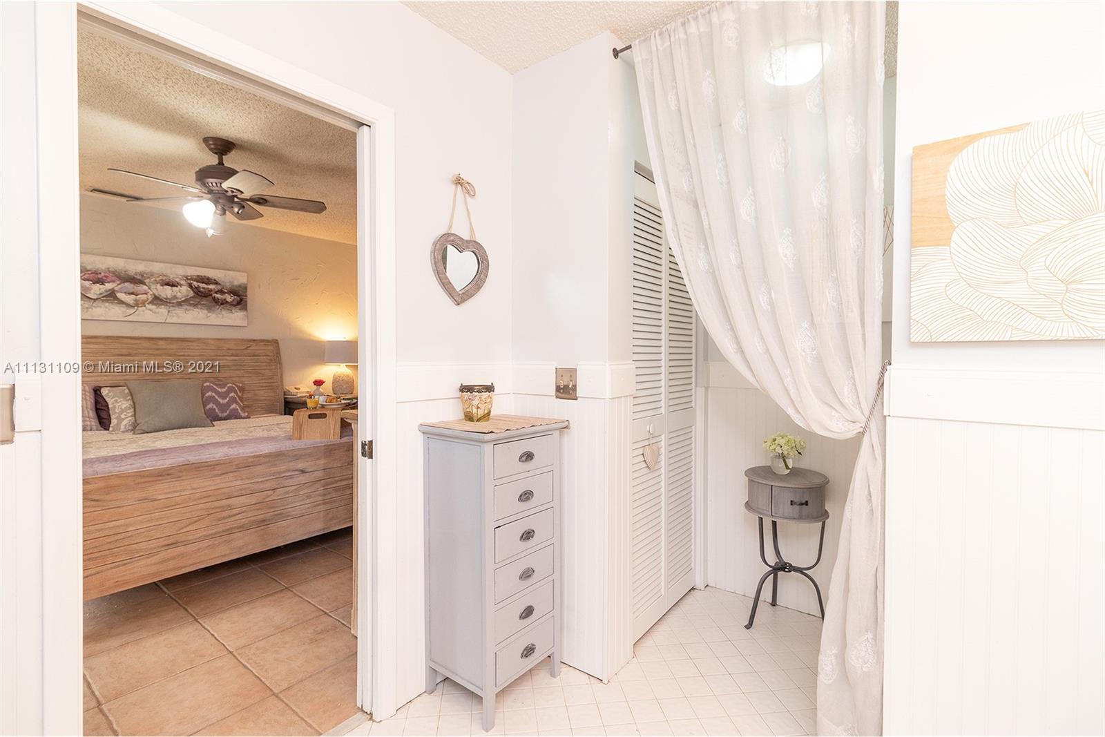 9248 Neptunes Basin Court Boca Raton, FL 33434 - Photo 25 of 34 a bathroom with a bathtub sink and mirror