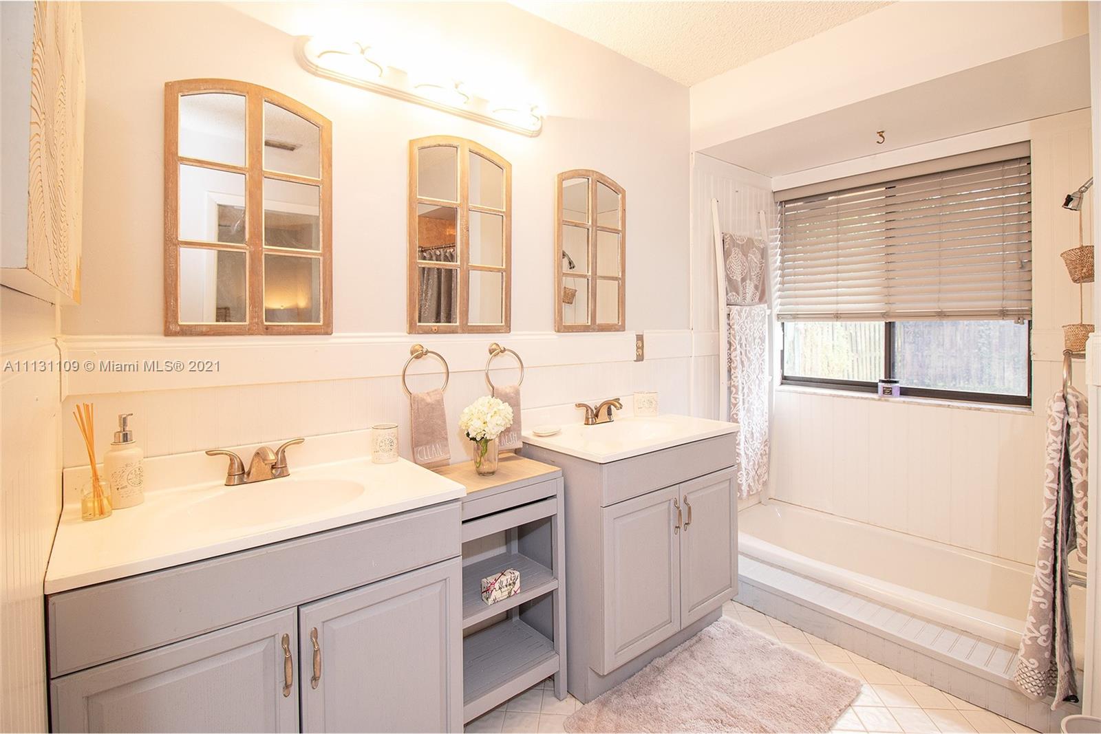 9248 Neptunes Basin Court Boca Raton, FL 33434 - Photo 26 of 34 a bathroom with a sink and a mirror