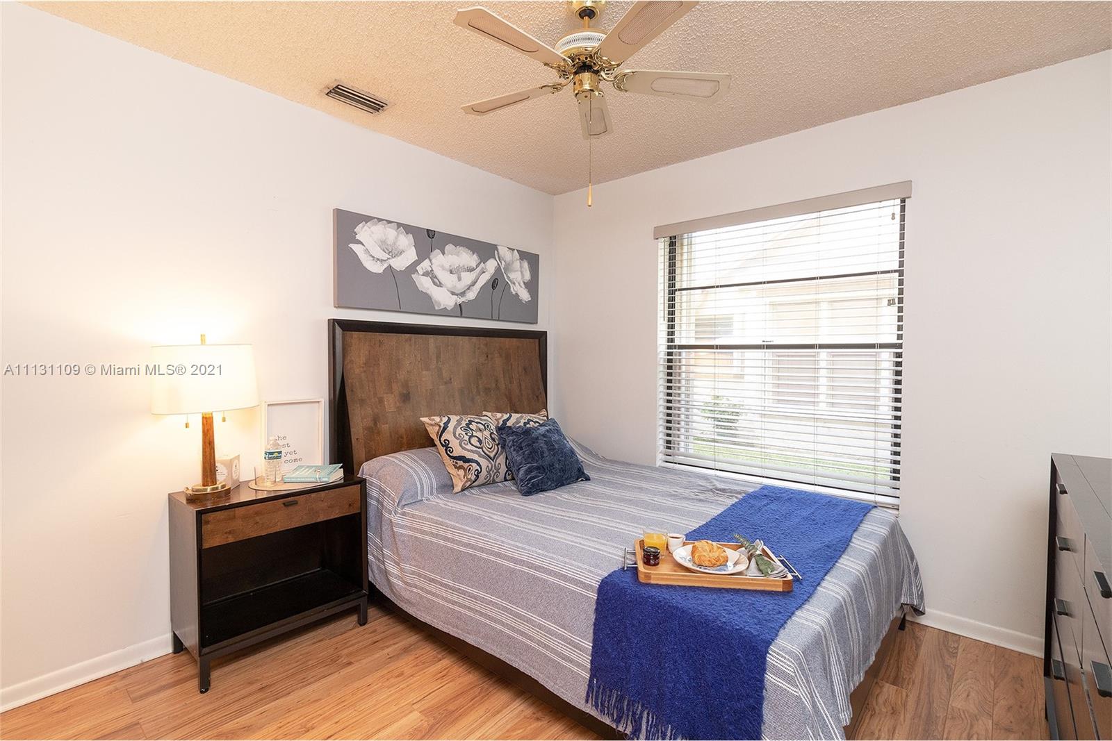 9248 Neptunes Basin Court Boca Raton, FL 33434 - Photo 28 of 34 a bedroom with a bed and a window with the outer view