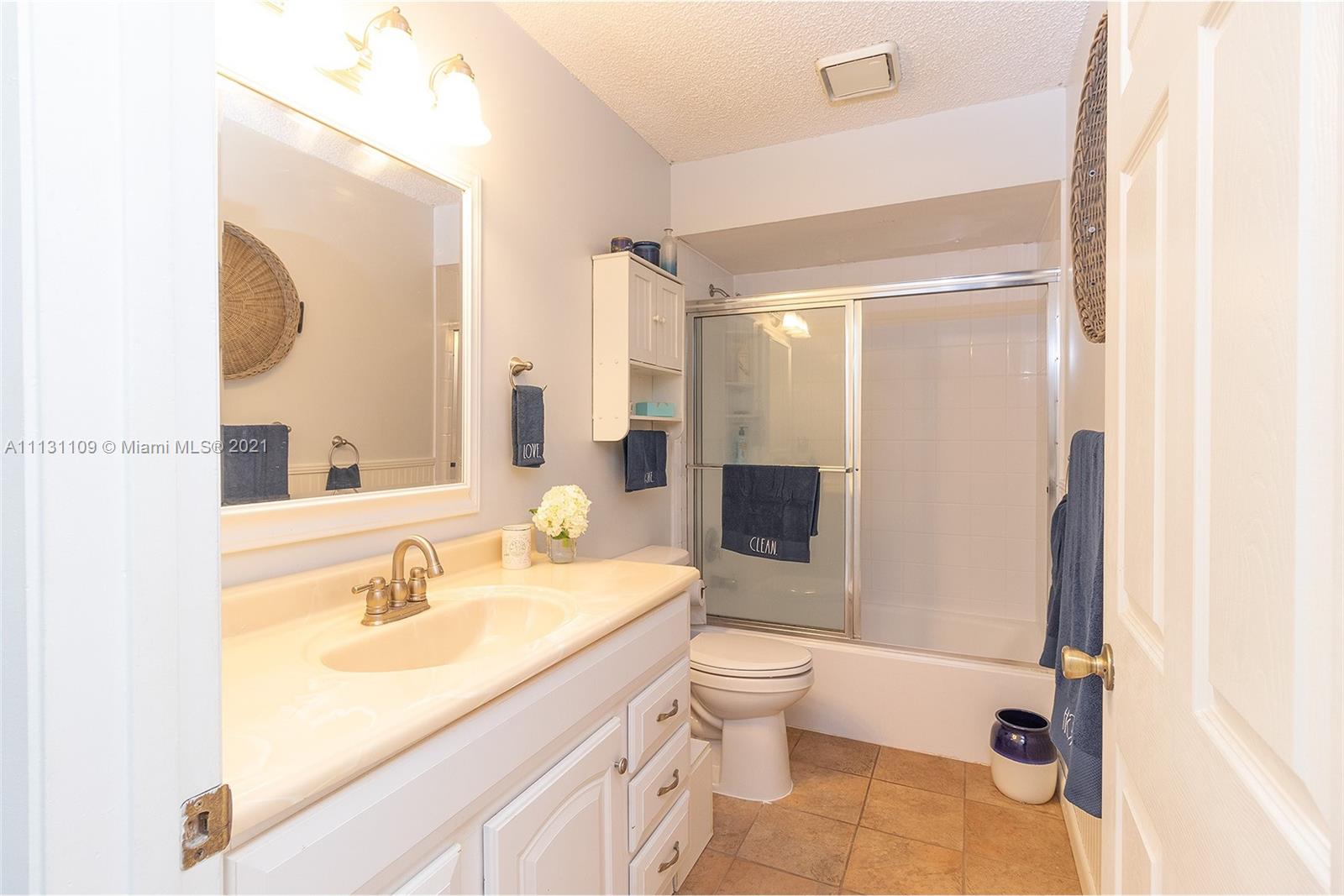 9248 Neptunes Basin Court Boca Raton, FL 33434 - Photo 30 of 34 a bathroom with a sink a toilet and a mirror