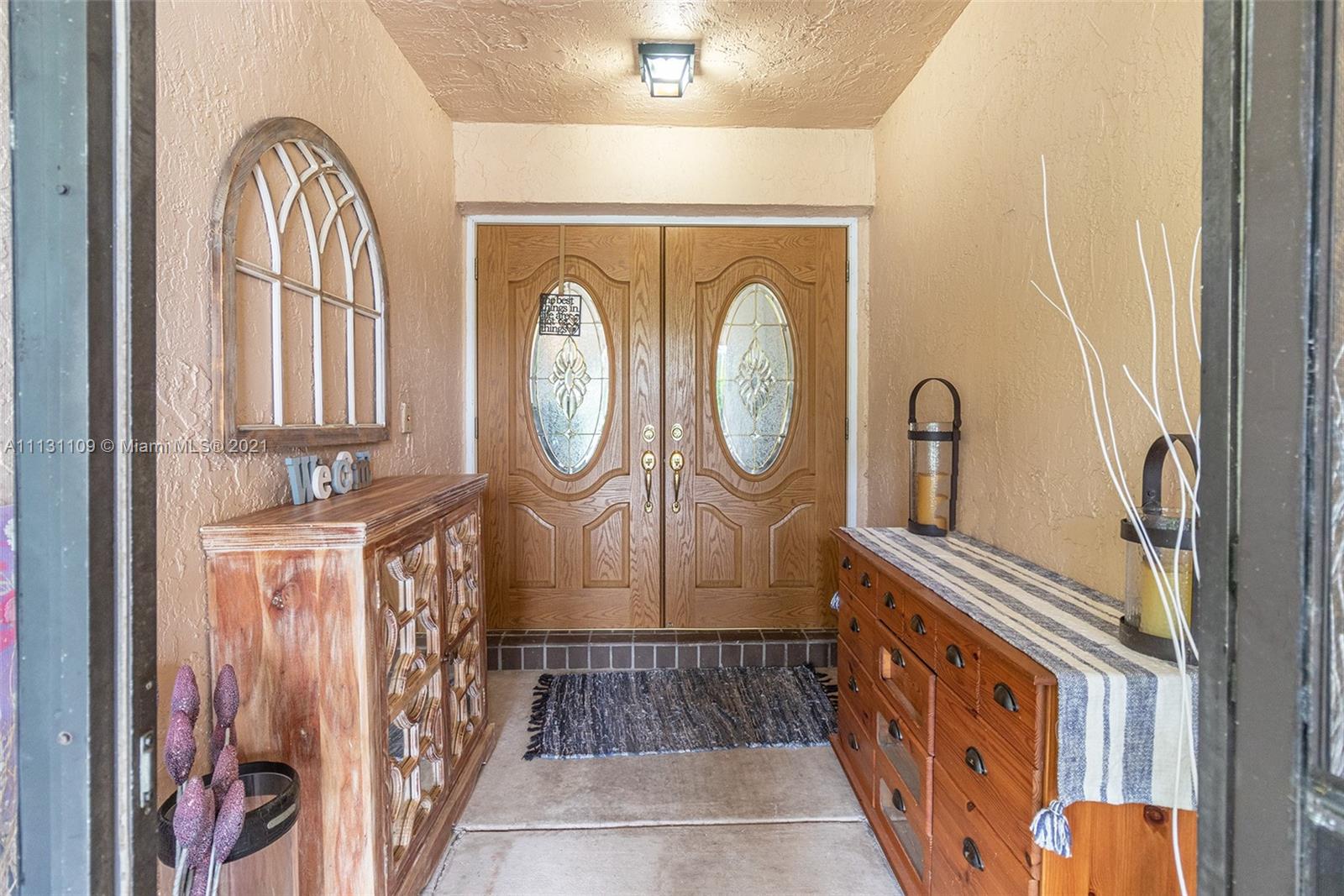 9248 Neptunes Basin Court Boca Raton, FL 33434 - Photo 4 of 34 a view of a entryway door with wooden floor