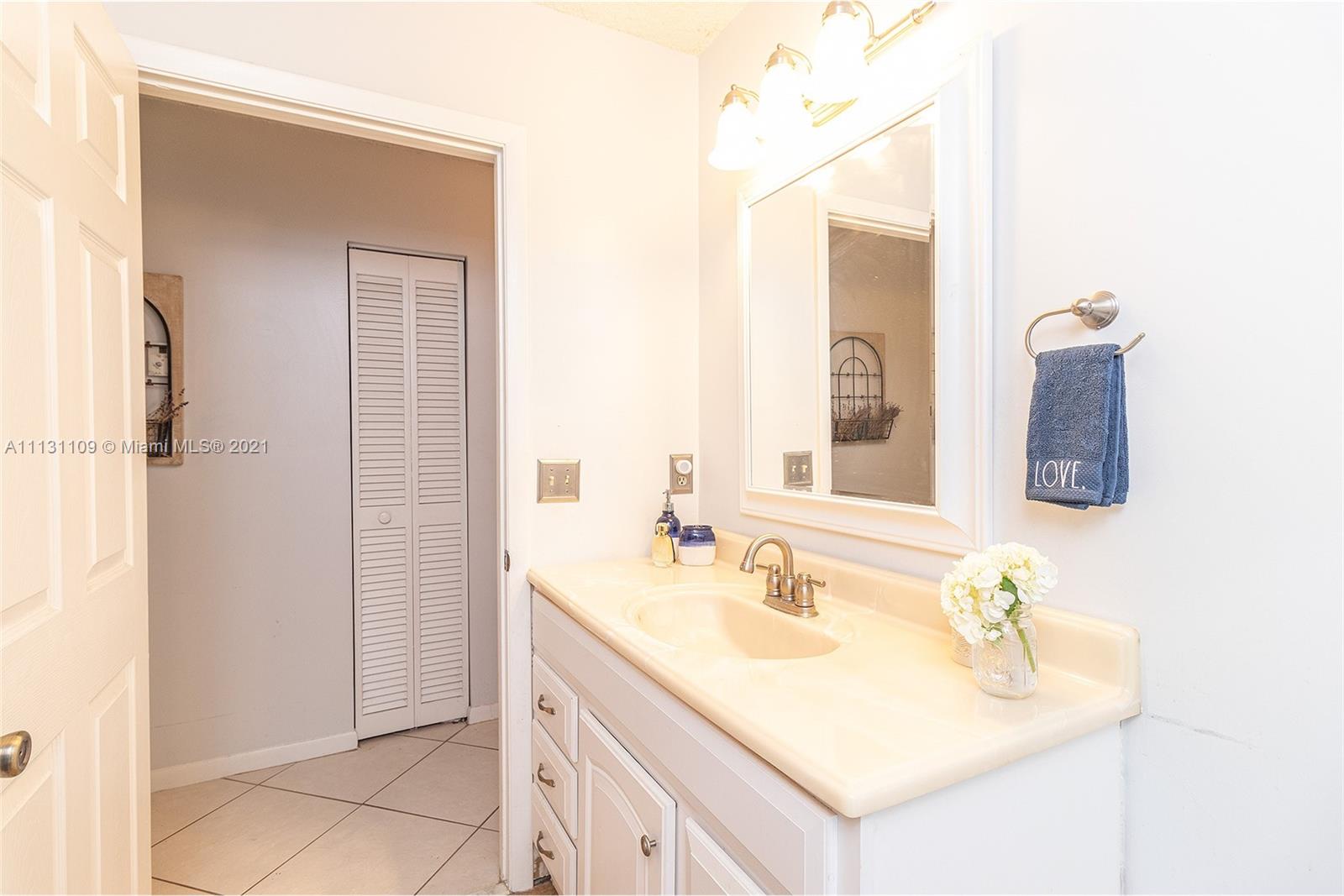9248 Neptunes Basin Court Boca Raton, FL 33434 - Photo 31 of 34 a bathroom with a sink vanity and a mirror