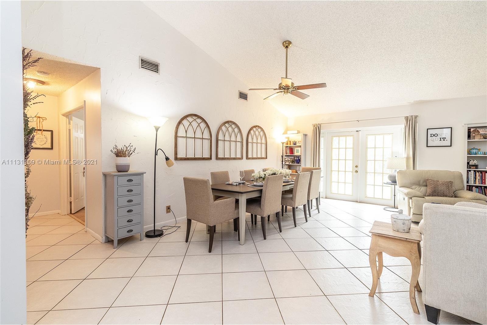 9248 Neptunes Basin Court Boca Raton, FL 33434 - Photo 8 of 34 a view of a livingroom with furniture a dinning table and chandelier