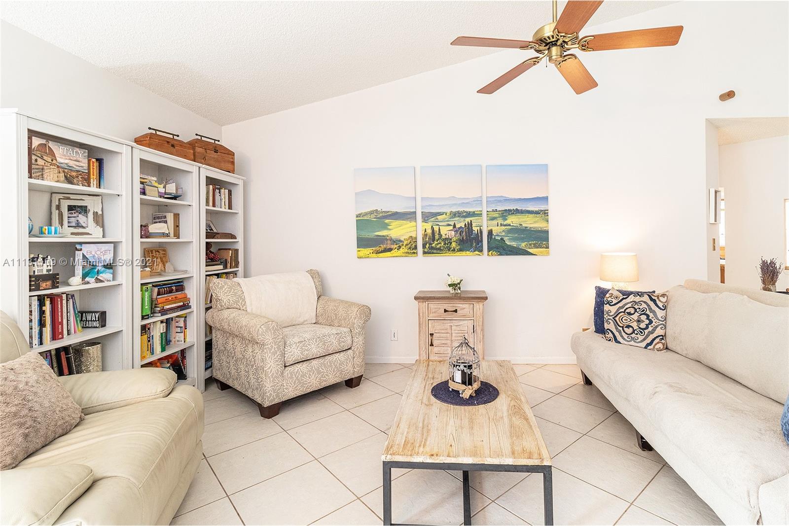 9248 Neptunes Basin Court Boca Raton, FL 33434 - Photo 10 of 34 a living room with furniture and a book shelf
