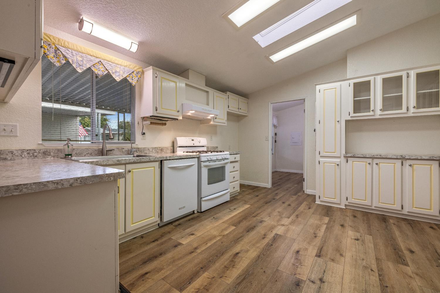 2621 Prescott Road, Unit 87 Modesto, CA 95350 - Photo 12 of 31 a kitchen with stainless steel appliances granite countertop a sink stove and a refrigerator
