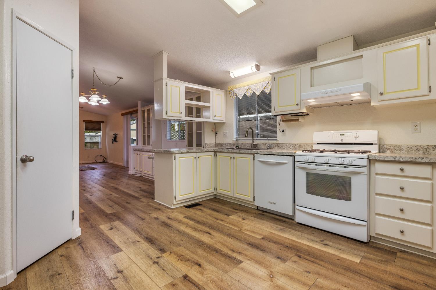 2621 Prescott Road, Unit 87 Modesto, CA 95350 - Photo 14 of 31 a kitchen with a stove cabinets and wooden floor
