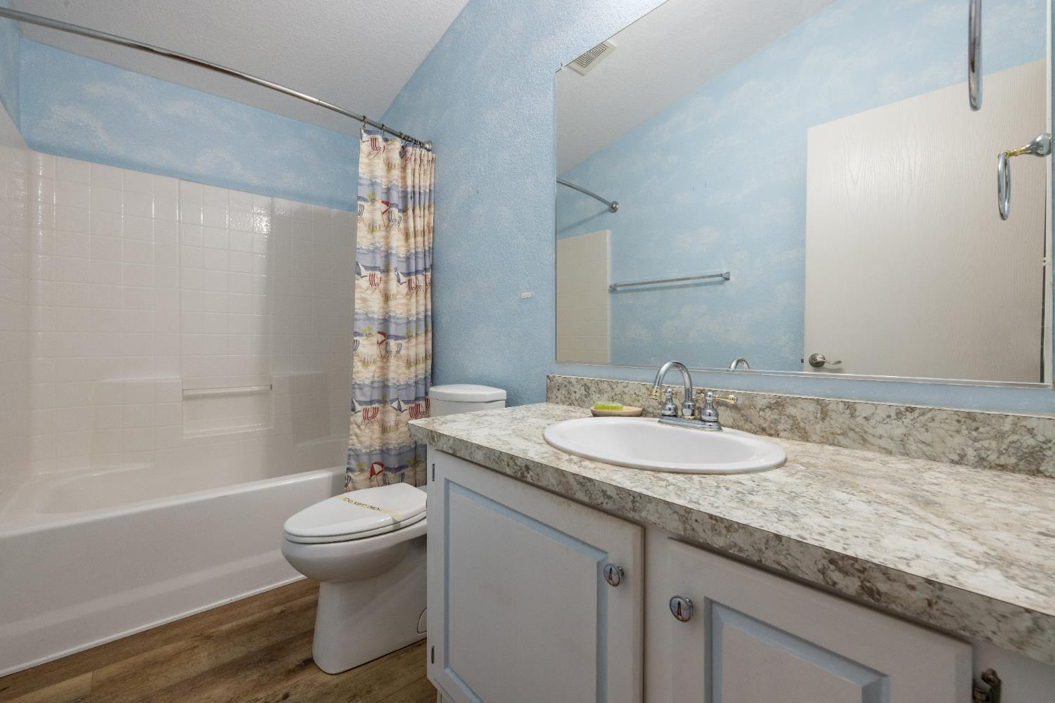 2621 Prescott Road, Unit 87 Modesto, CA 95350 - Photo 22 of 31 a bathroom with a granite countertop sink toilet and shower