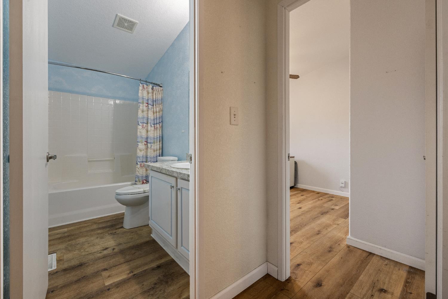 2621 Prescott Road, Unit 87 Modesto, CA 95350 - Photo 23 of 31 a bathroom with a granite countertop toilet a sink and a mirror