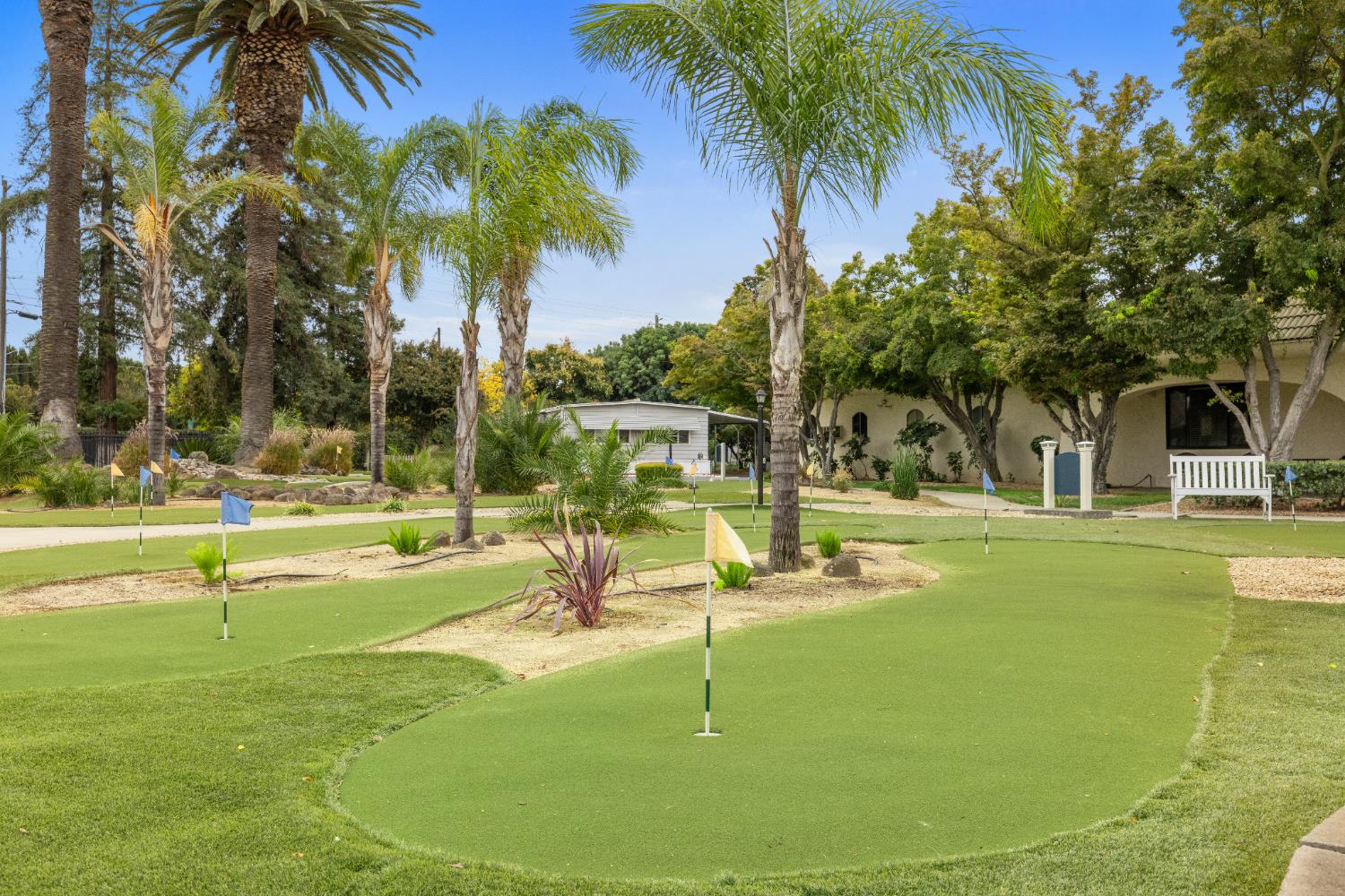 2621 Prescott Road, Unit 87 Modesto, CA 95350 - Photo 31 of 31 a view of a swimming pool with a lawn chairs under palm trees