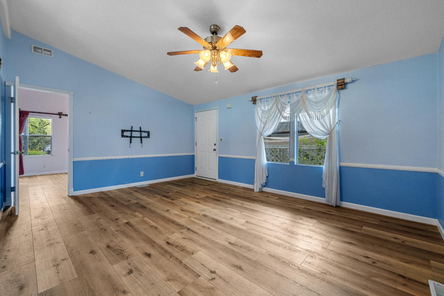 2621 Prescott Road, Unit 87 Modesto, CA 95350 - Photo 6 of 31 a view of an empty room with window and wooden floor