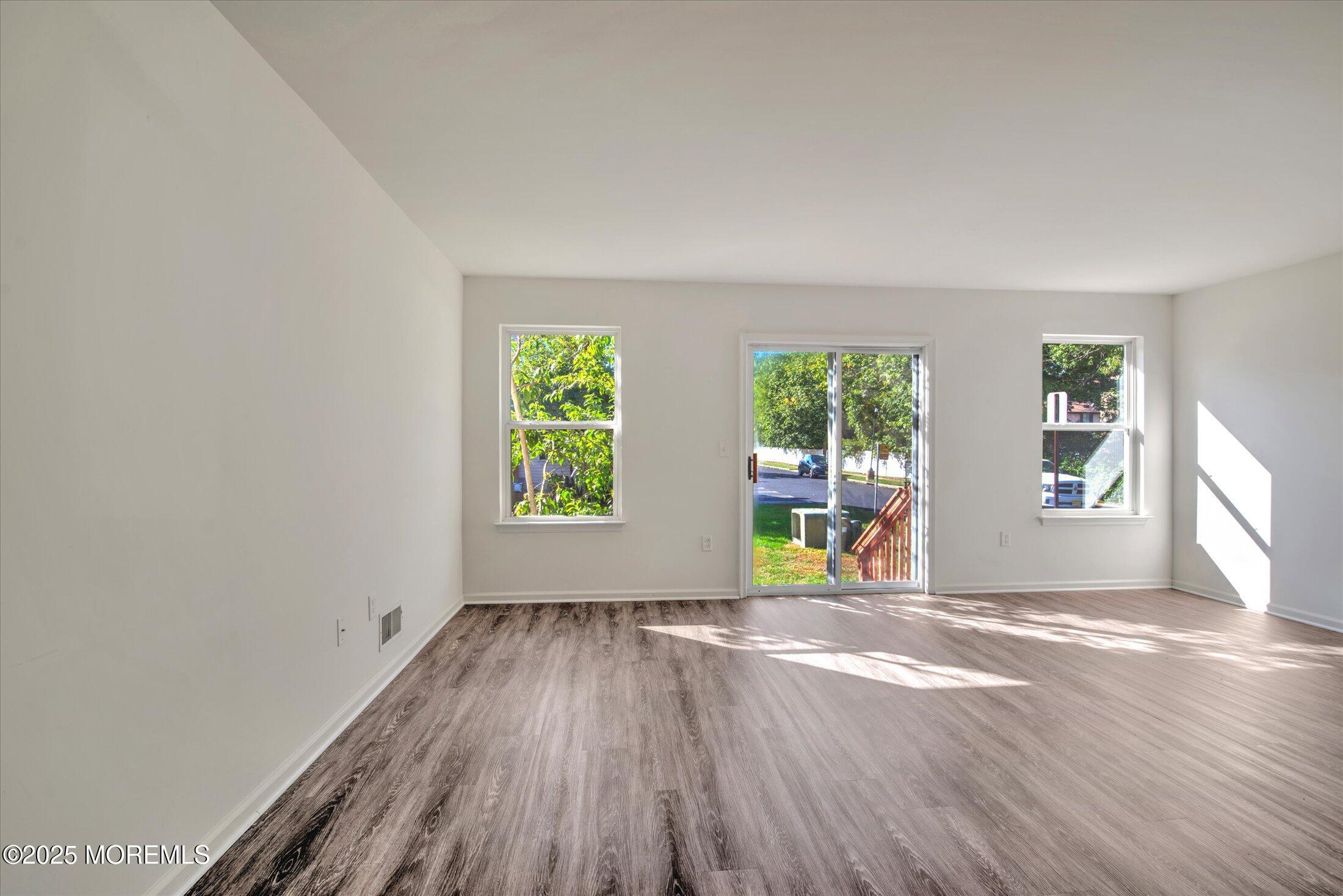 1 Esplanade Way Bayville, NJ 08721 - Photo 11 of 41 wooden floor in an empty room with a window