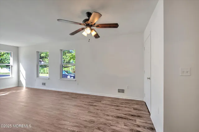 wooden floor in an empty room with a window