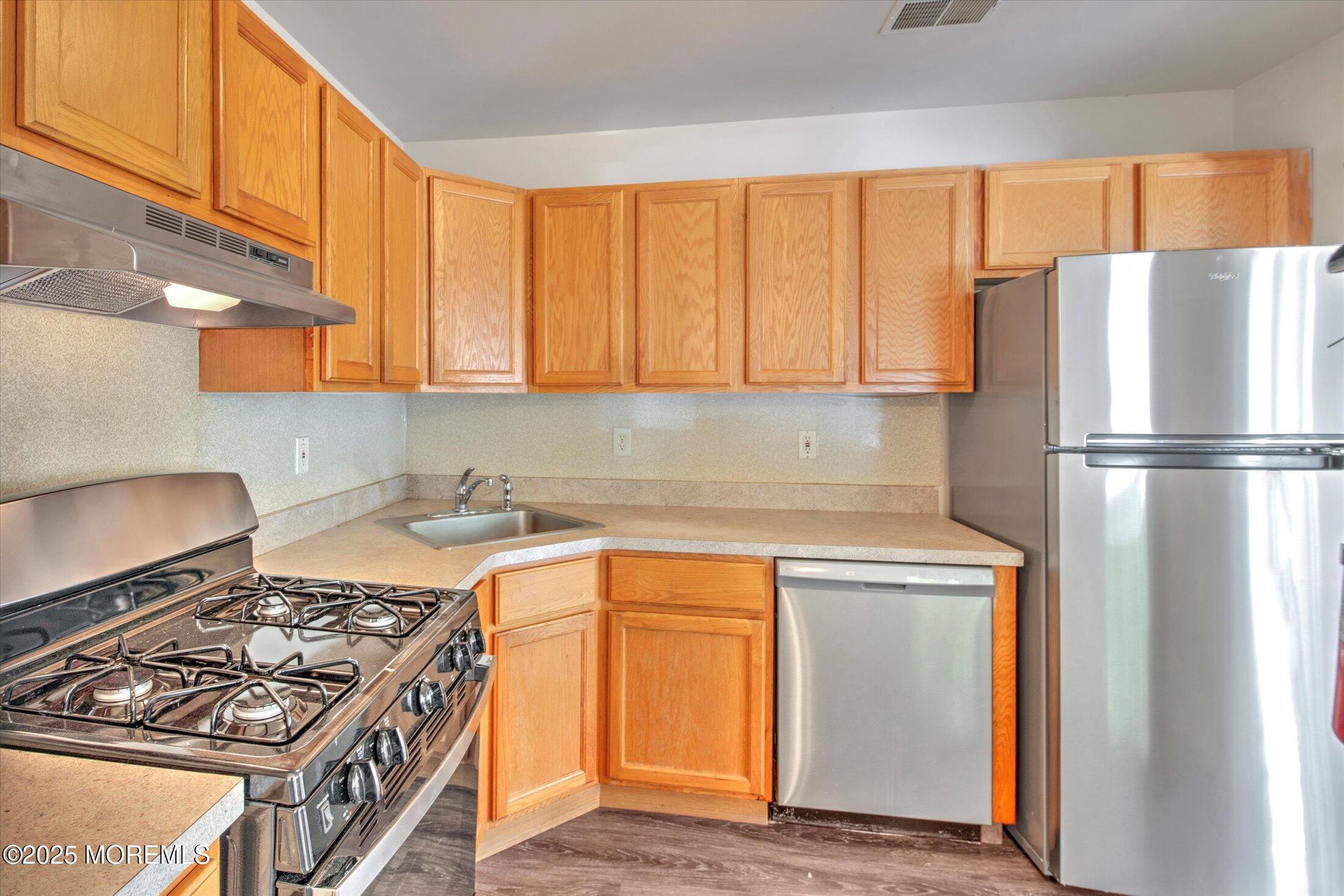 1 Esplanade Way Bayville, NJ 08721 - Photo 17 of 41 a kitchen with a stove and a refrigerator