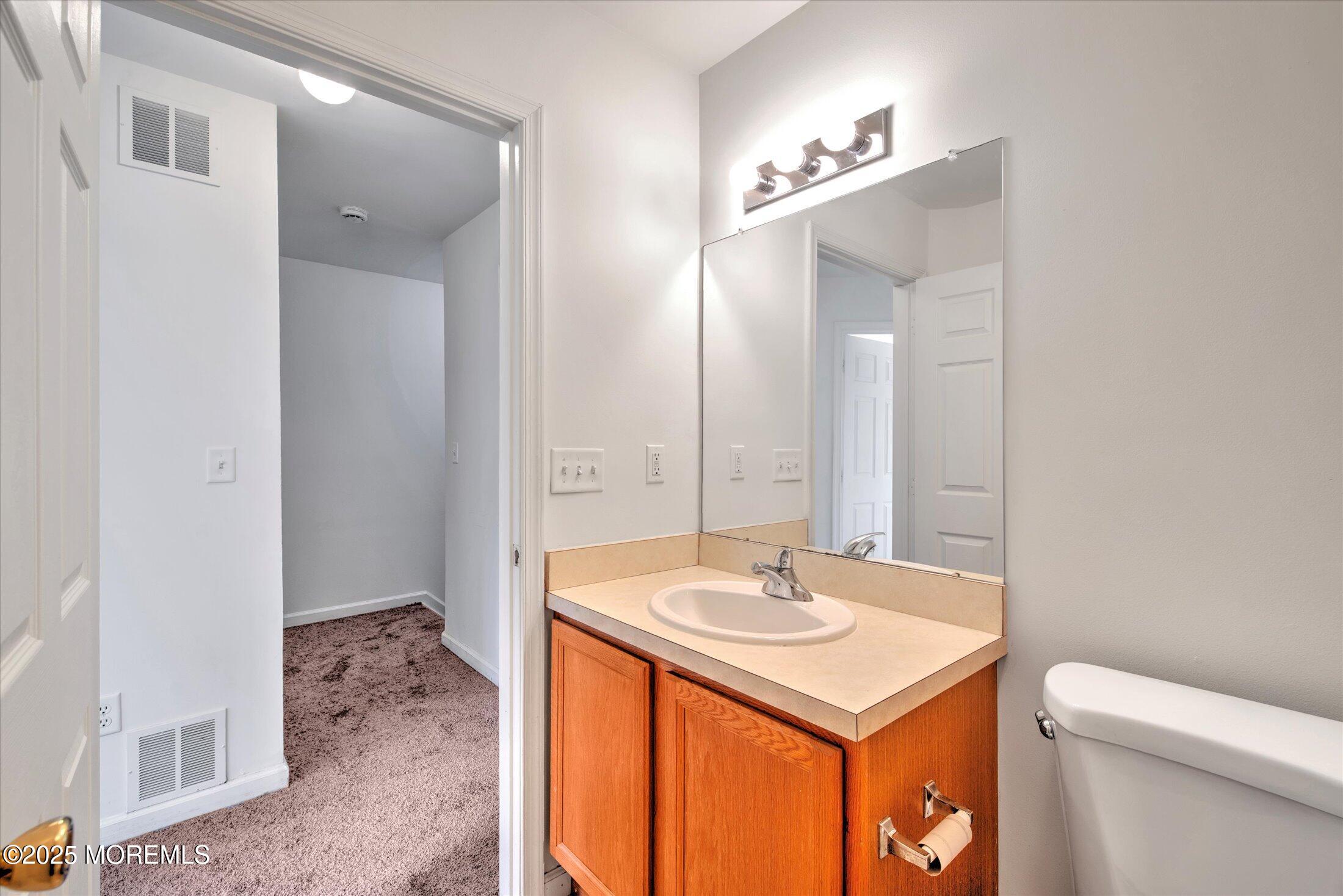 1 Esplanade Way Bayville, NJ 08721 - Photo 35 of 41 a bathroom with a sink and a mirror