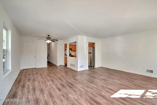 a view of a room with wooden floor