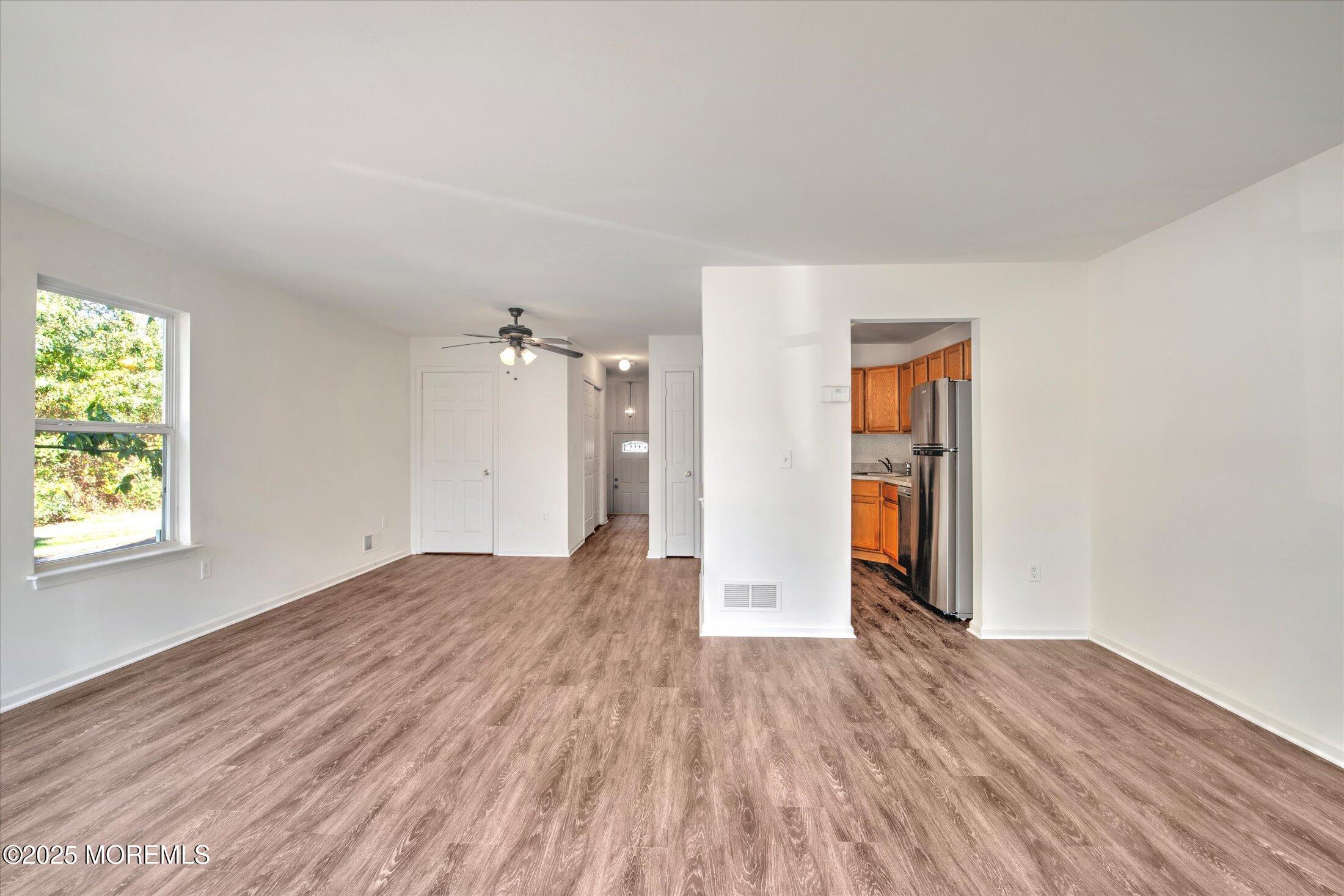 1 Esplanade Way Bayville, NJ 08721 - Photo 7 of 41 an empty room with wooden floor and windows