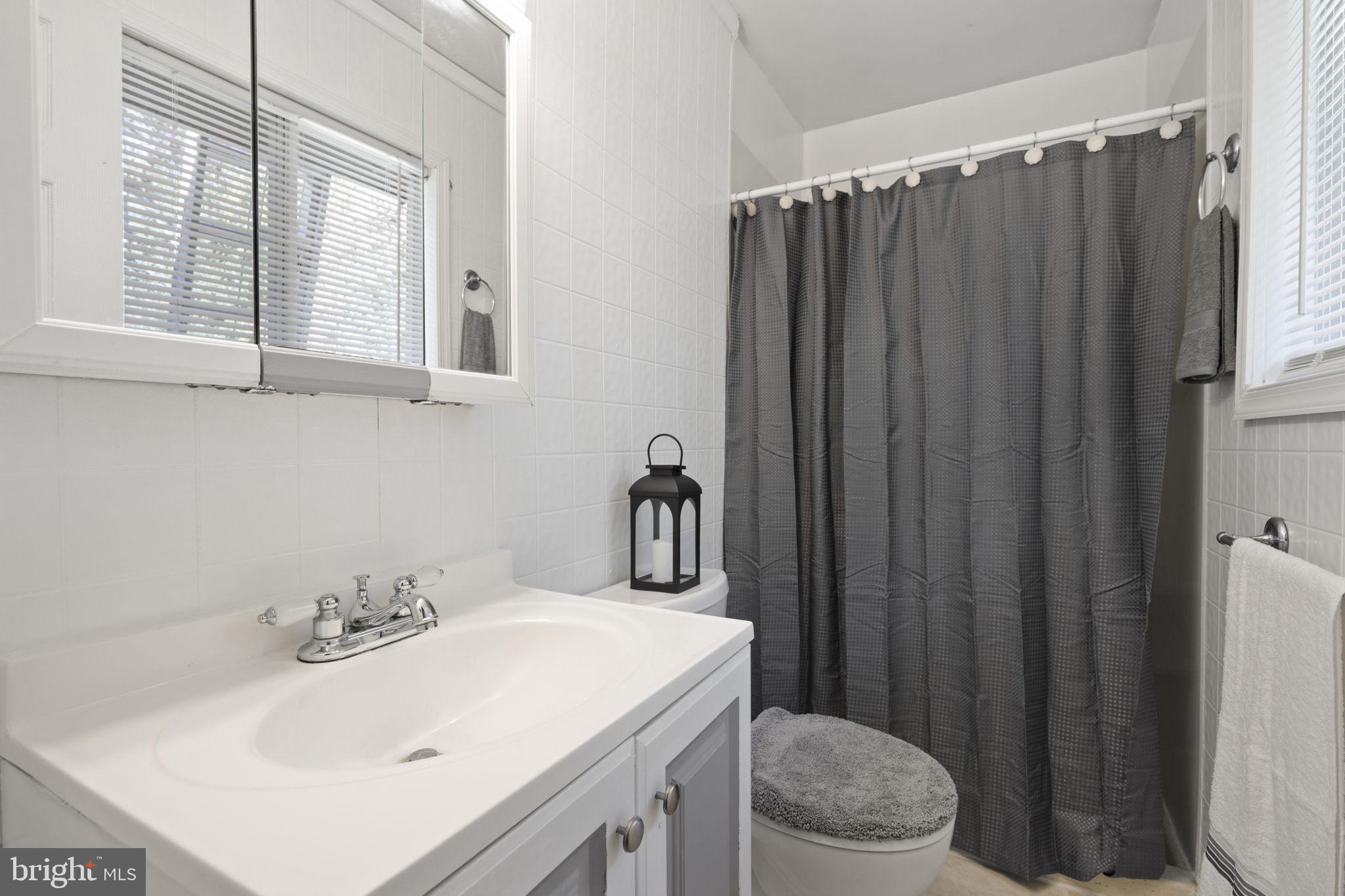 1775 Pleasantville Road Forest Hill, MD 21050 - Photo 11 of 35 a bathroom with a sink a toilet and shower