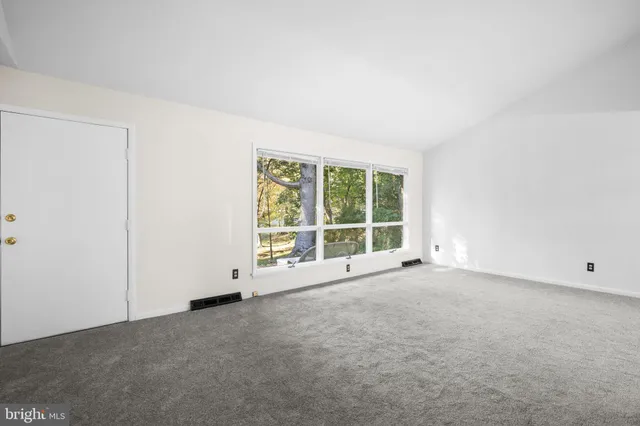 an empty room with a large window
