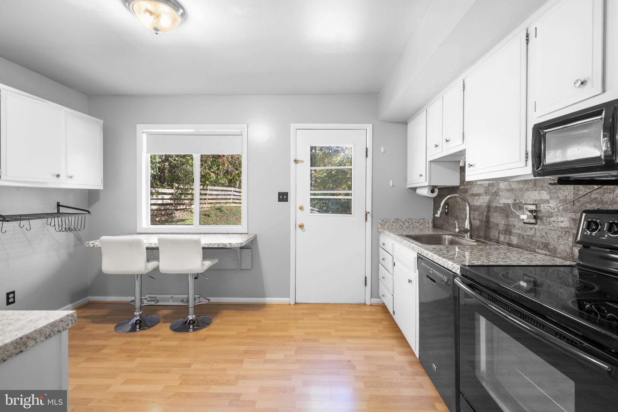 1775 Pleasantville Road Forest Hill, MD 21050 - Photo 7 of 35 a kitchen with a stove a sink and a microwave
