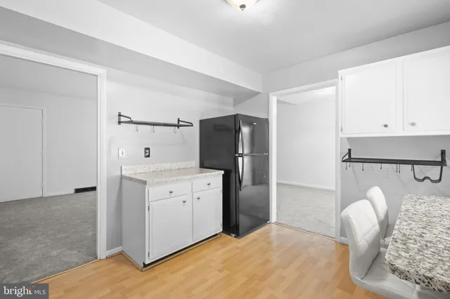 a kitchen with cabinets and refrigerator