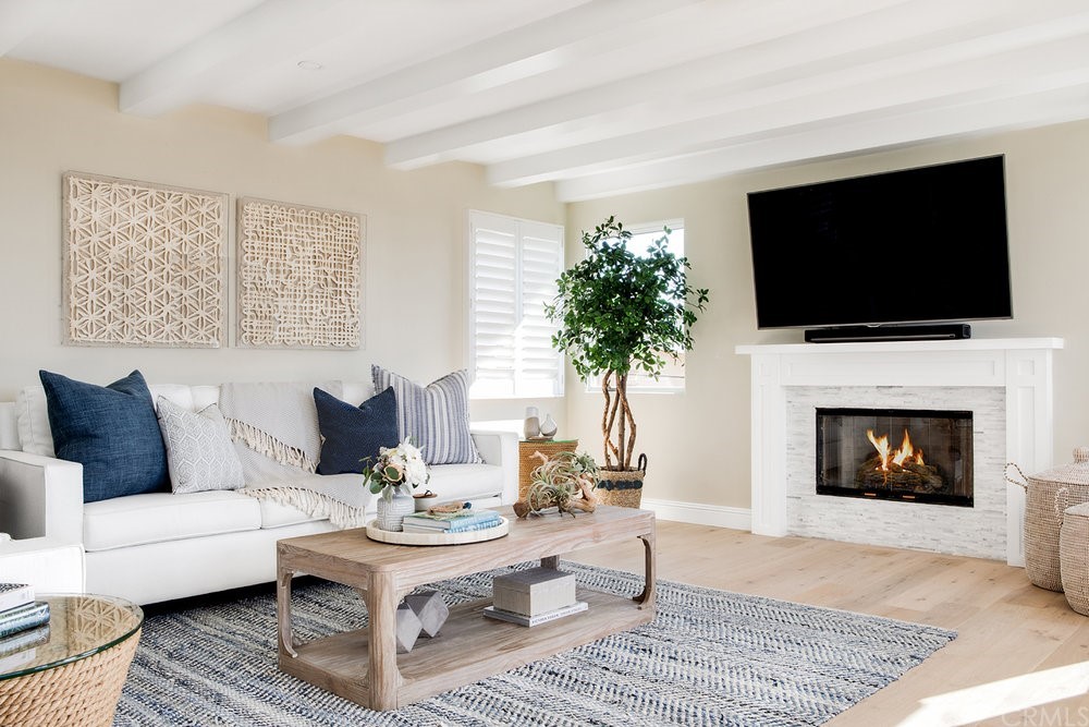 329 21st Place Manhattan Beach, CA 90266 - Photo 5 of 18 a living room with furniture a flat screen tv and a fireplace