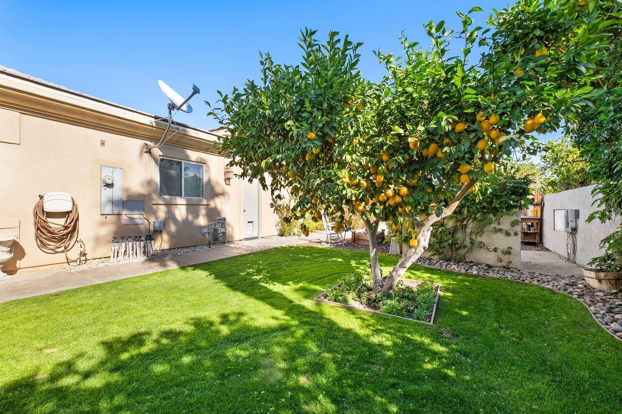 42128 May Pen Road Bermuda Dunes, CA 92203 - Photo 16 of 32 a backyard of a house with table and chairs