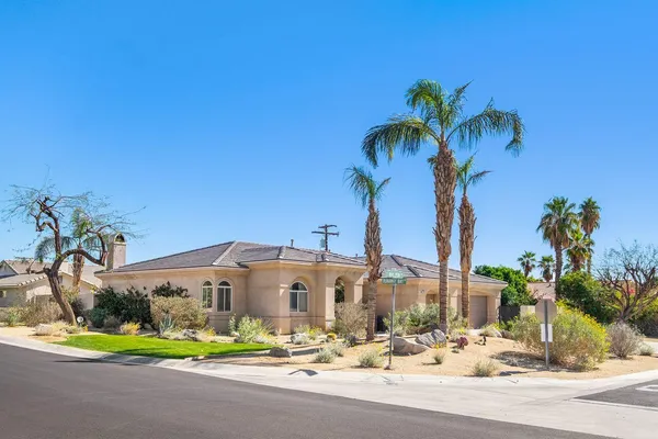 a front view of multiple house with small garden