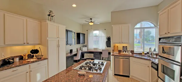 a kitchen with a sink stove and refrigerator