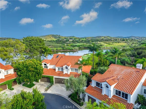 an aerial view of a house with garden space and street view
