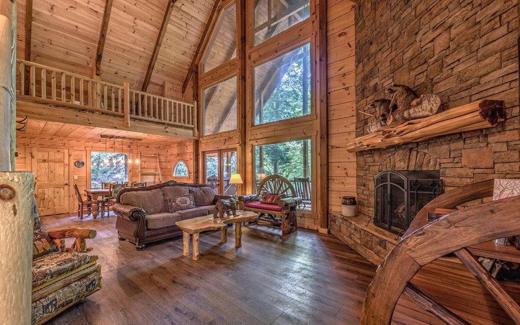 343 Muller Lane Ellijay, GA 30540 - Photo 11 of 35 a living room with furniture a fireplace and a floor to ceiling window